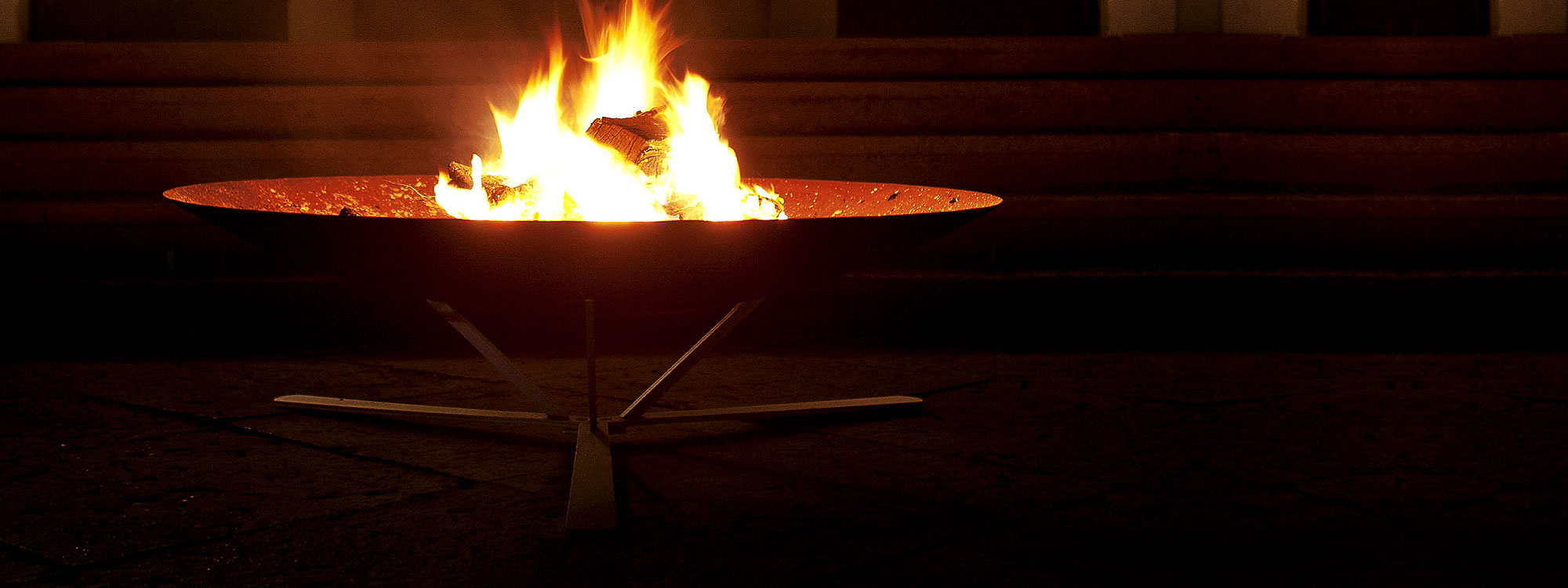 Slow exposure Image of flames within Discolo fire bowl stood on galvanized steel tripod by AK47 Design