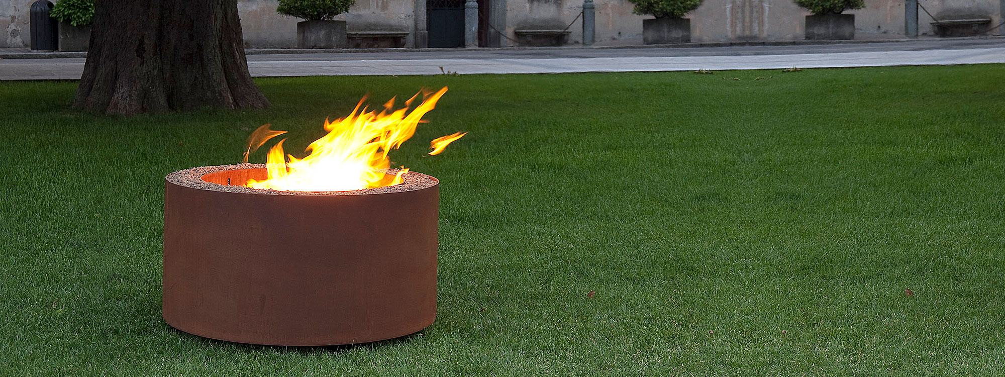 Image of flaming Mangiafuoco fire pit in vintage brown finish by AK47 Design