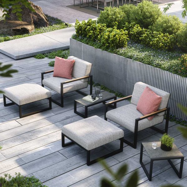 Image of pair of Ninix Lounge garden relax chairs and foot stools with ceramic side tables by Royal Botania