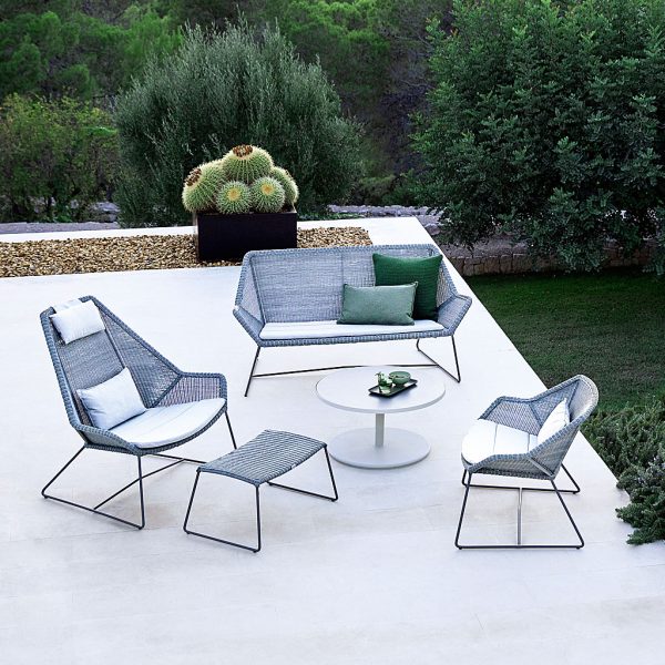 Image of white-grey Breeze outdoor lounge set by Cane-line, on raise terrace with cactus and planting in background