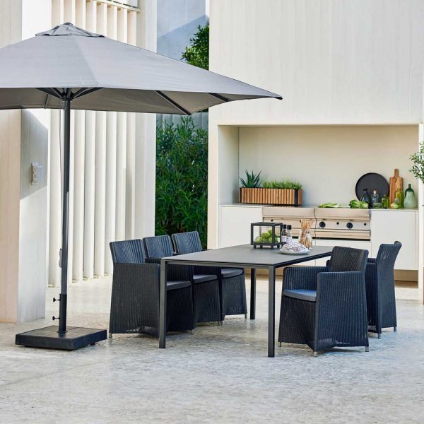 Image of Caneline Diamond traditional black garden chairs around a stainless steel outdoor table