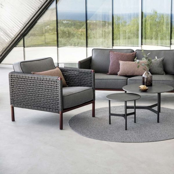 Image of Cane-line Encore garden sofa and lounge chair with Bordeaux frames and Dark Grey weave and upholstery