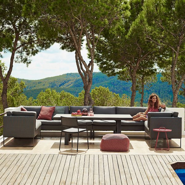 Image of Flex modular garden dining sofa around Caneline dining table on decked Mediterranean terrace