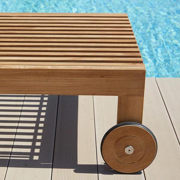 Image of detail of Amaze sun lounger's teak structure and wheels by Caneline