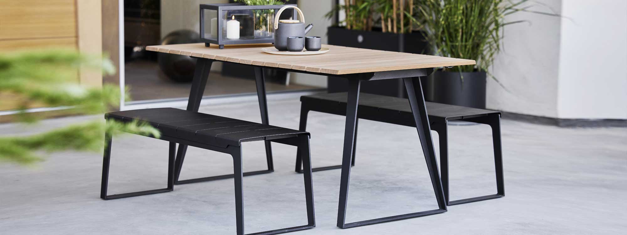 Image of pair of Copenhagen bench seats & Copenhagen dining table with teak top by Cane-line outdoor furniture