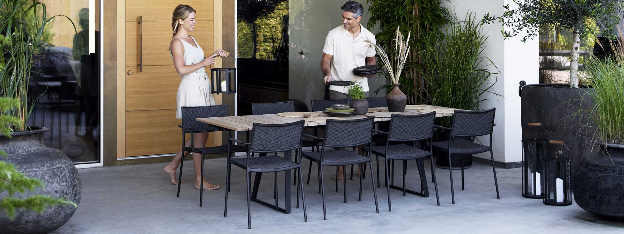 Image of Less Lava-grey chairs and Copenhagen garden table in Lava-grey aluminum with teak top by Caneline
