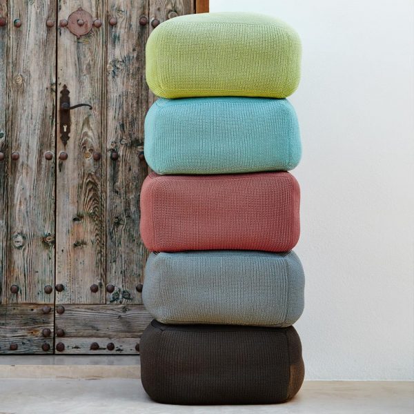 Image of stacked Divine outdoor poufs in different colors by Cane-line