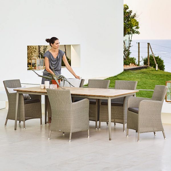Image of Hampsted taupe cane garden chairs around Core table with taupe base and teak top by Caneline