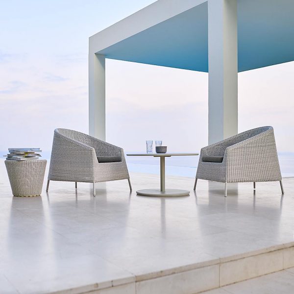 Image of white-grey Kingston synthetic rattan garden chairs by Cane-line, shown on white terrace