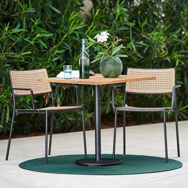 Image of Go round teak bistro table with Less garden chairs with natural French weave back and seat and lava-grey legs by Cane-line