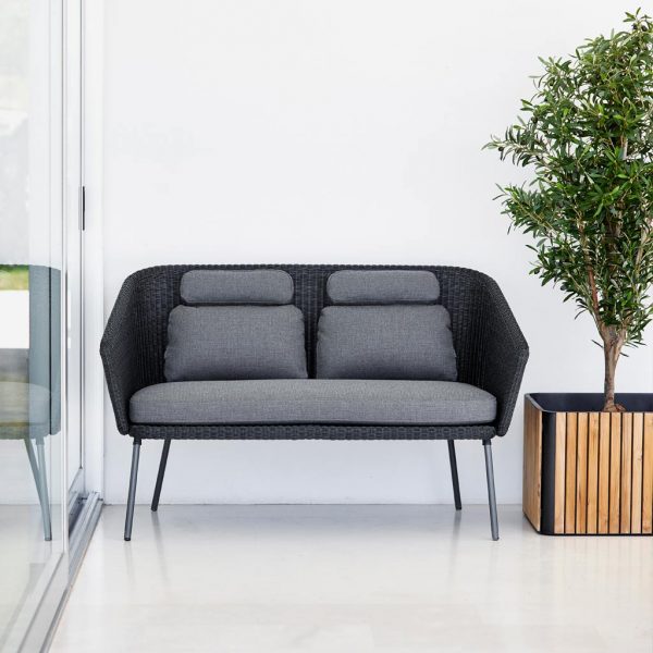 Image of Mega dark grey garden sofa next to Combine teak and grey planter by Cane-line