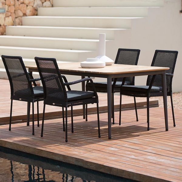 Image of Caneline Newport garden chairs and Core teak dining table on decked poolside