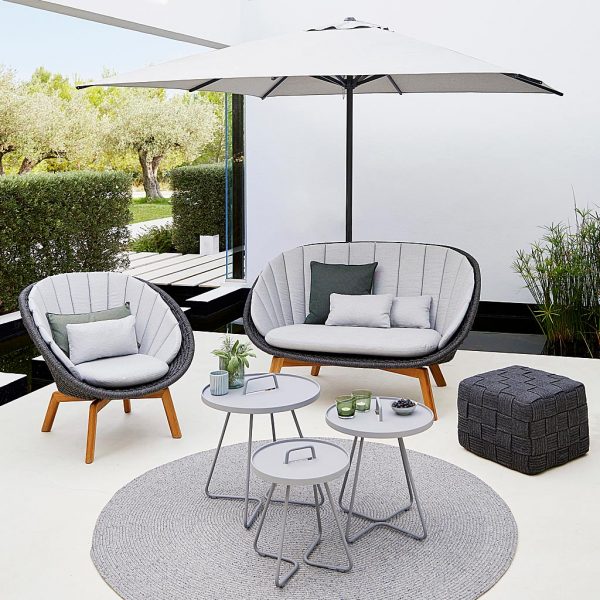 Image of Peacock garden sofa and easy chair with dark-grey Soft Rope body, light-grey cushions and teak legs by Cane-line