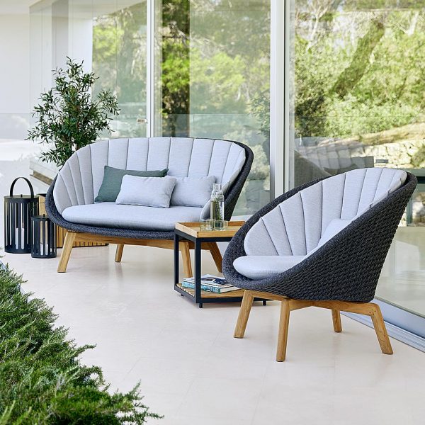 Image of Cane-line Peaock sofa and lounge chair in dark-grey Soft Rope and teak legs