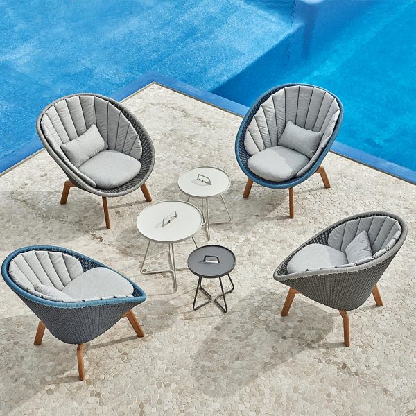 Image of aerial view of 4 Peacock outdoor easy chairs and Twist garden low tables by Cane-line, on chic poolside