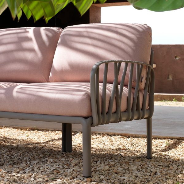 Image of detail of Komodo modern plastic garden sofa's arms and frame in polypropylene fibreglass with rose coloured cushions