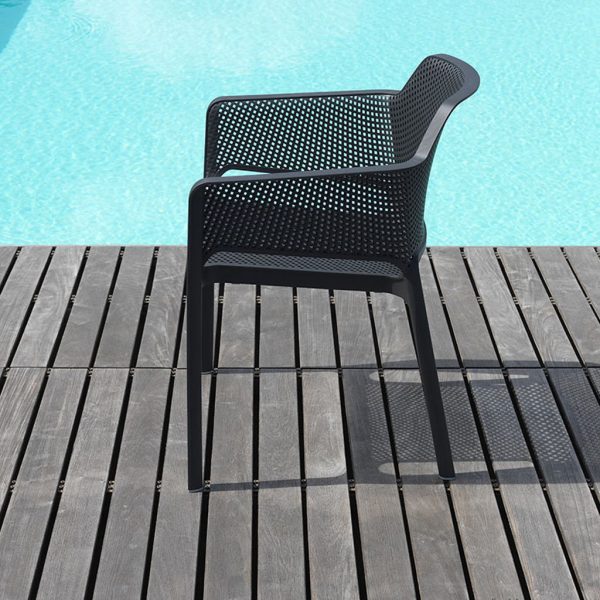 Image of side profile of Nardi Net black garden chair on wooden-decked poolside