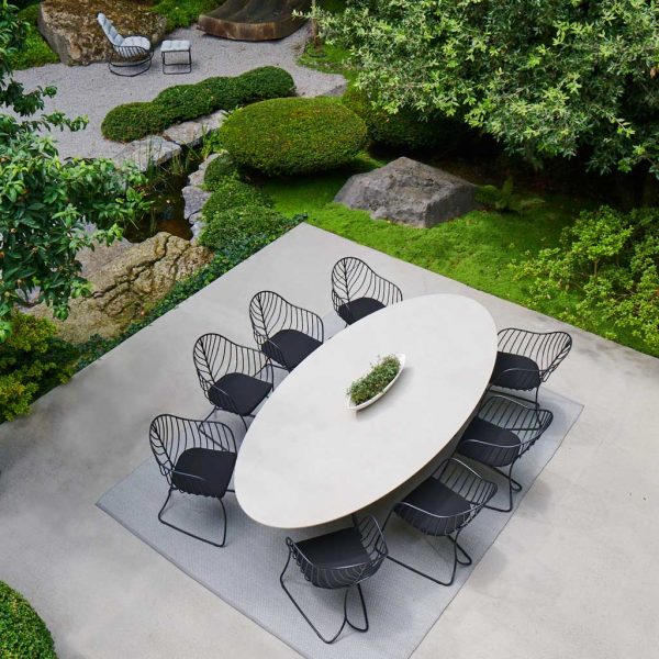 Birdseye image of Conix elliptical concrete table & Folia chairs by Royal Botania