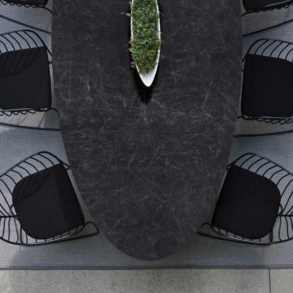 Image of details of Conix oval table top in dark Nero Marquina marble-effect ceramic & Folia black chairs by Royal Botania
