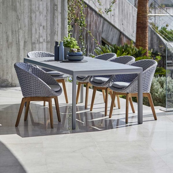 Image of light-grey Peacock dining chairs and Drop garden table by Cane-line