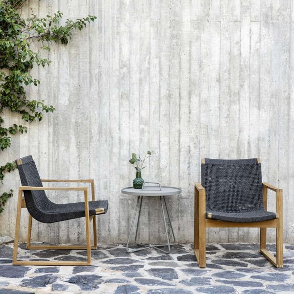 Image of pair of Cane-line Endless garden lounge chairs with teak frame and dark-grey woven SoftRope seat & back