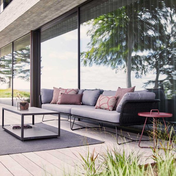 Image of anthracite rattan corner sofa and low table by Caneline on sleek modern terrace