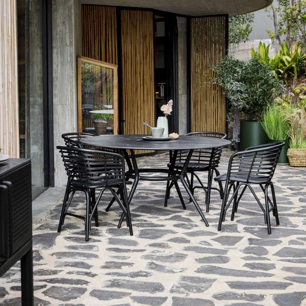 Image of black Joy circular garden dining table and black Blend chairs by Caneline