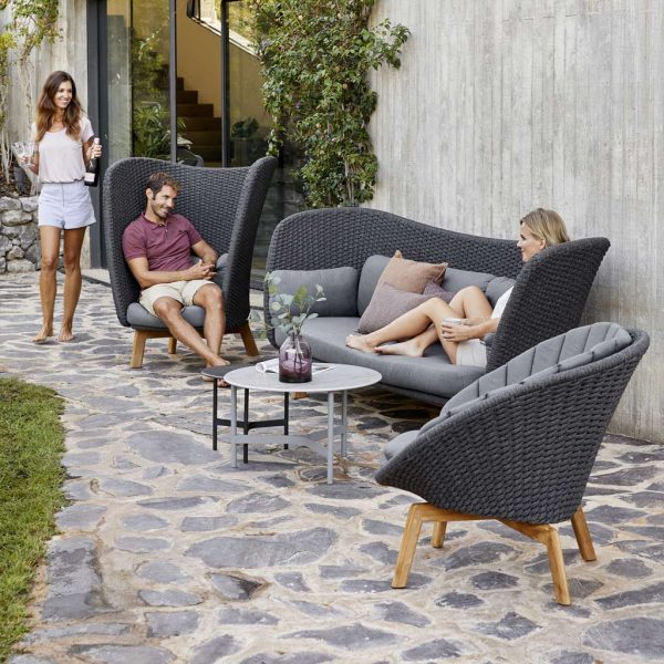 Image of Peacock Wing high backed lounge furniture and Peacock lounge chair on terrace by Caneline