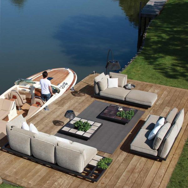 Image of birdseye view of lakeside installation of Royal Botania Mozaix Alu sofa, with Riva speed boat moored alongside pontoon.