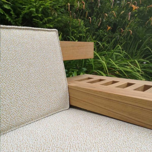 Detail of Royal Botania Nara teak garden bench arm and luxury upholstery