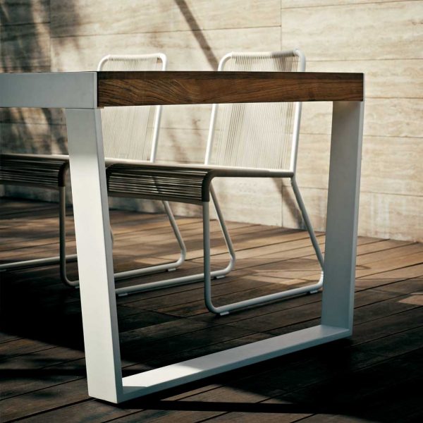 Image of detail of Spinnaker modern extending exterior table with teak top and white powder coated stainless steel base