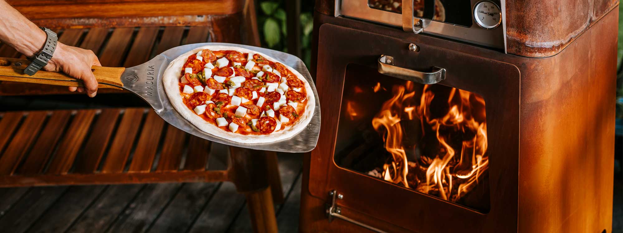 M-Classic pizza oven is a multifunctional outdoor fireplace & modern pizza oven in stainless or corten steel by Masuria wood fired pizza oven co.