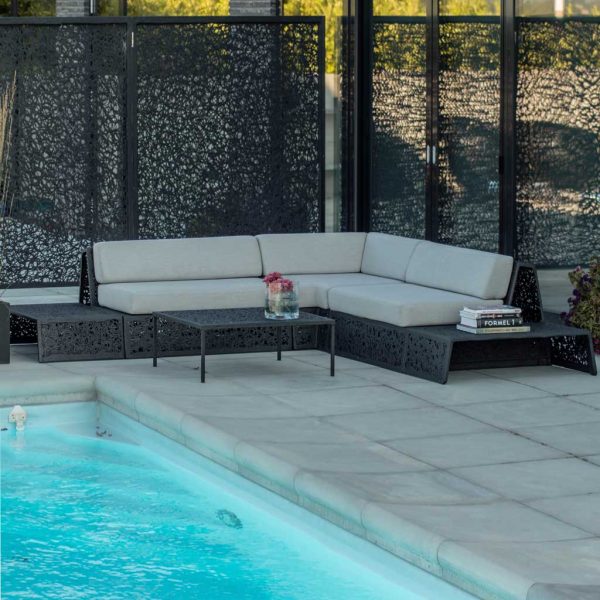 Image of black Bios Lounge outdoor sofa and Lava fence panels by Unknown Nordic on poolside