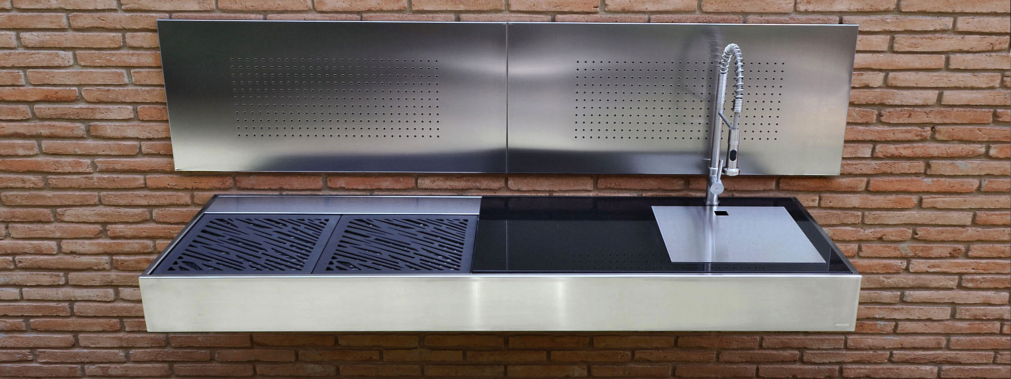 KRAKATOA Wall Mounted BBQ Is A Modern BBQ With Sink. Luxury Stainless Steel Barbecue Is Available As A Modern Solid Fuel BBQ Or A Functional Gas BBQ. Designed & Made By FESFOC, Catalunya.