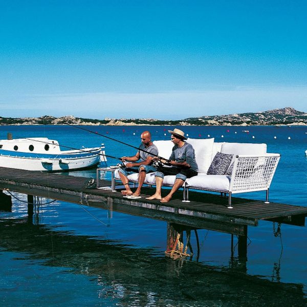 Image of two Italian gents sat on Nest garden sofa, fishing from wooden pontoon.