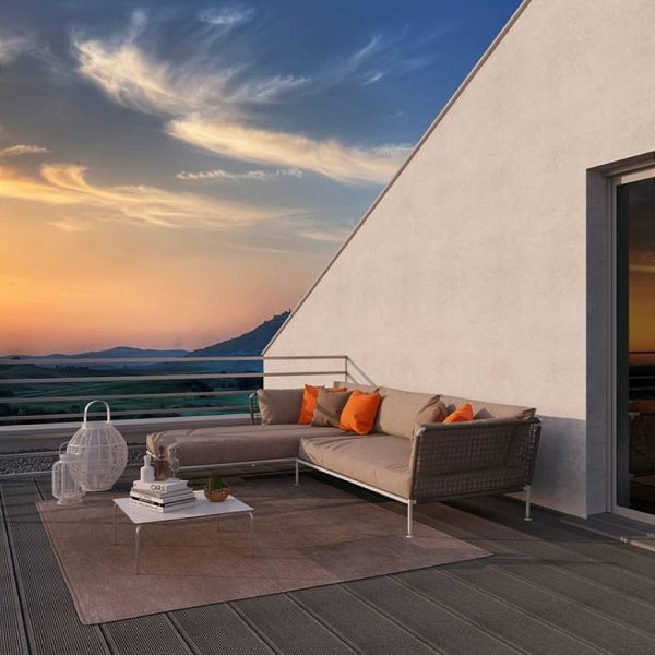 Image of Coro Nest modern garden sofa with integrated daybed, on rooftop terrace at dusk
