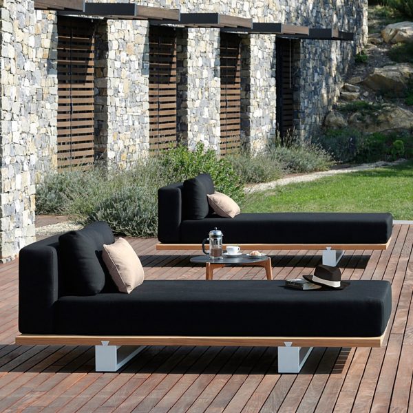 Image of pair of Royal Botania Vigor Lounge daybeds with teak bases and dark grey upholstery