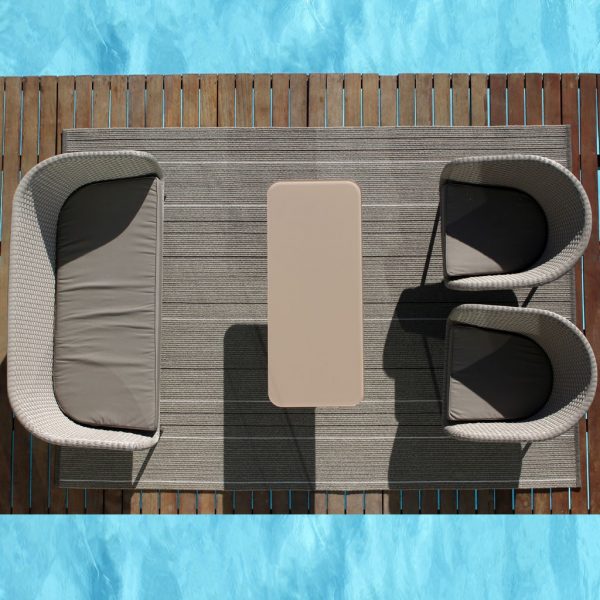 Birdseye view of Shell 2 seat garden sofa and lounge chairs on outdoor carpet next to swimming pool