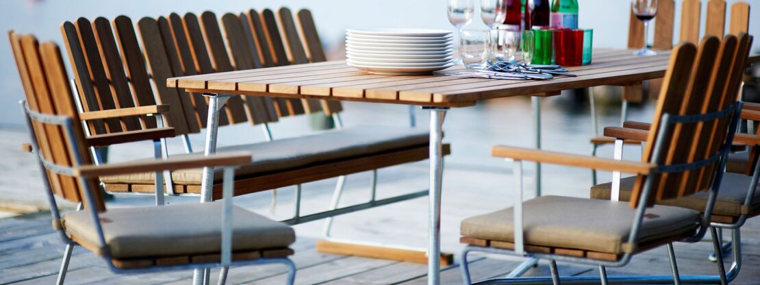 Image of A2 cantilever garden chair and rectangular garden table with galvanised steel frames and teak surfaces by Grythyttan Stålmobler