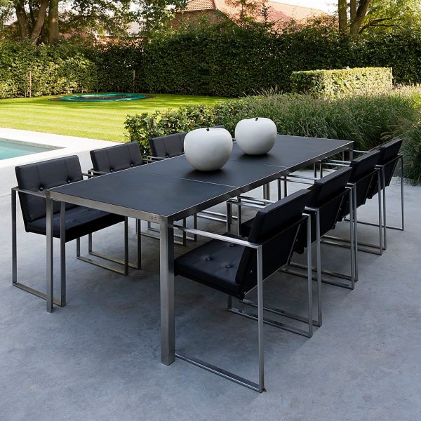 Image of Nimio modern garden table and Butaque dining chairs in brushed stainless steel by FueraDentro