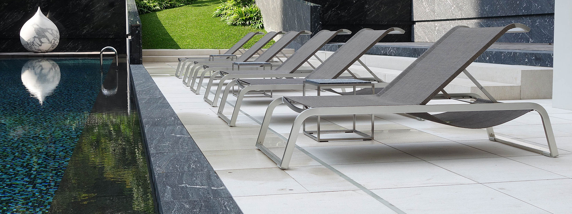 Image of row of L3 sun loungers along poolside