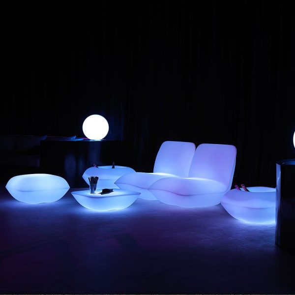 Image of Pillow outdoor lounge furniture by Vondom illuminated blue in the darkness