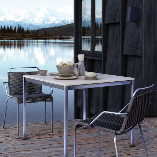 Image of pair of Coro Jubeae modern garden chairs with stainless steel frames an taupe acryclic rope seat and back, with lake and snowy mountains in the background