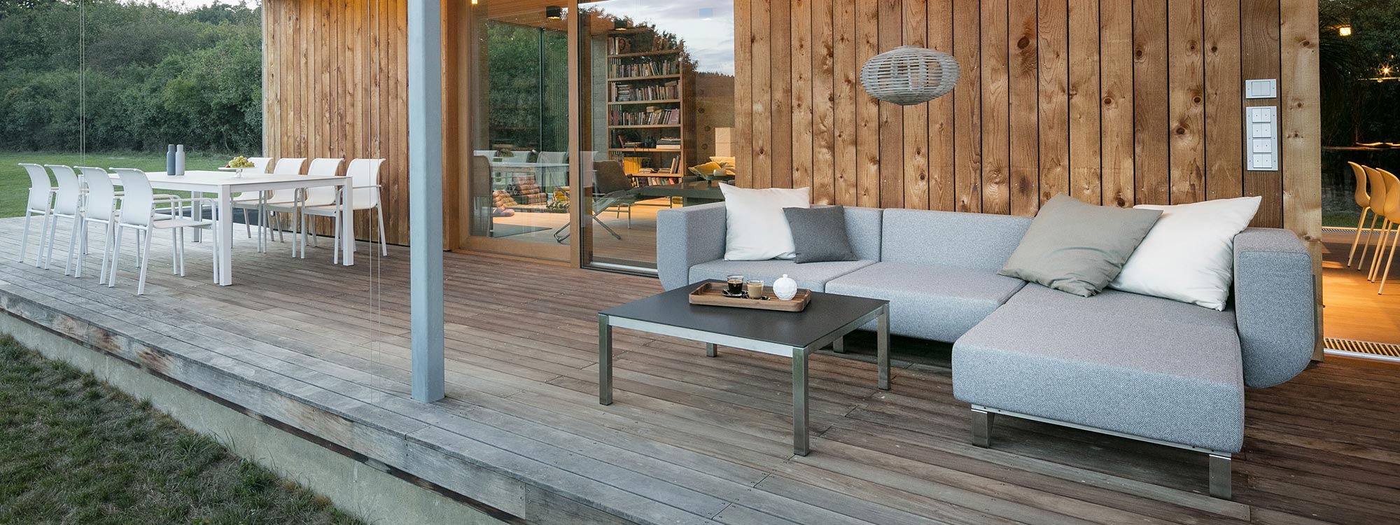 Image of Lotos garden sofa and Puro garden dining set on wooden decking
