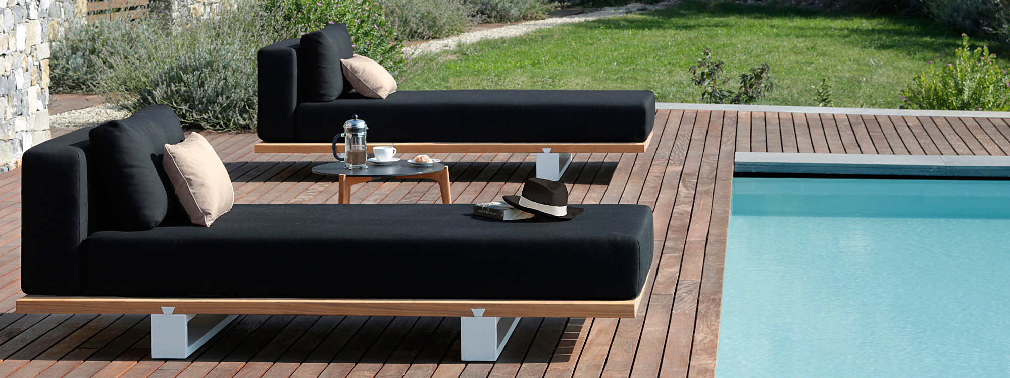 Image of pair of Vigor Lounge daybeds by Royal Botania around poolside