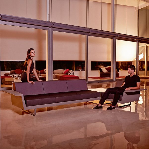 Nighttime interior image of couple sat on Vondom Delta minimalist sofa