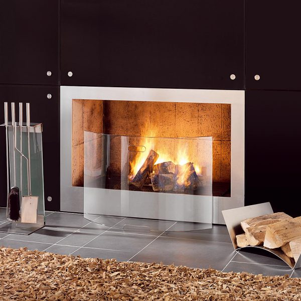 Image of Conmoto Mentas curved glass fire guard and Teras stainless steel fire tools in front of dancing flames in modern fireplace