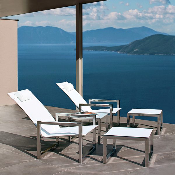 Image of pair of Ninix adjustable relax chairs and foot stools in electro-polished stainless steel on terrace high above Mediterranean coast