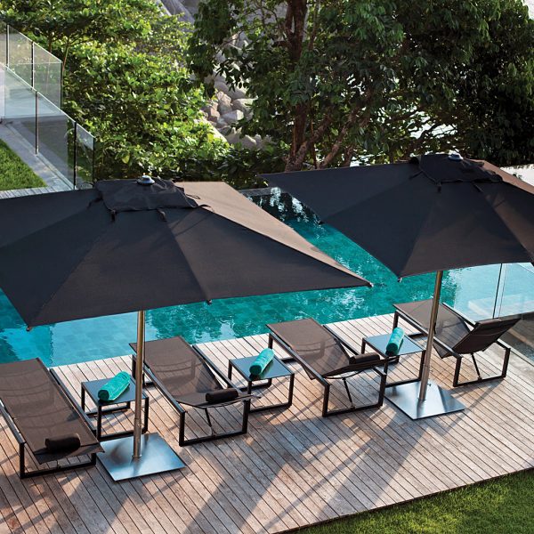 Birdseye image of black Shady parasols & black Ninix sun loungers by Royal Botania along poolside