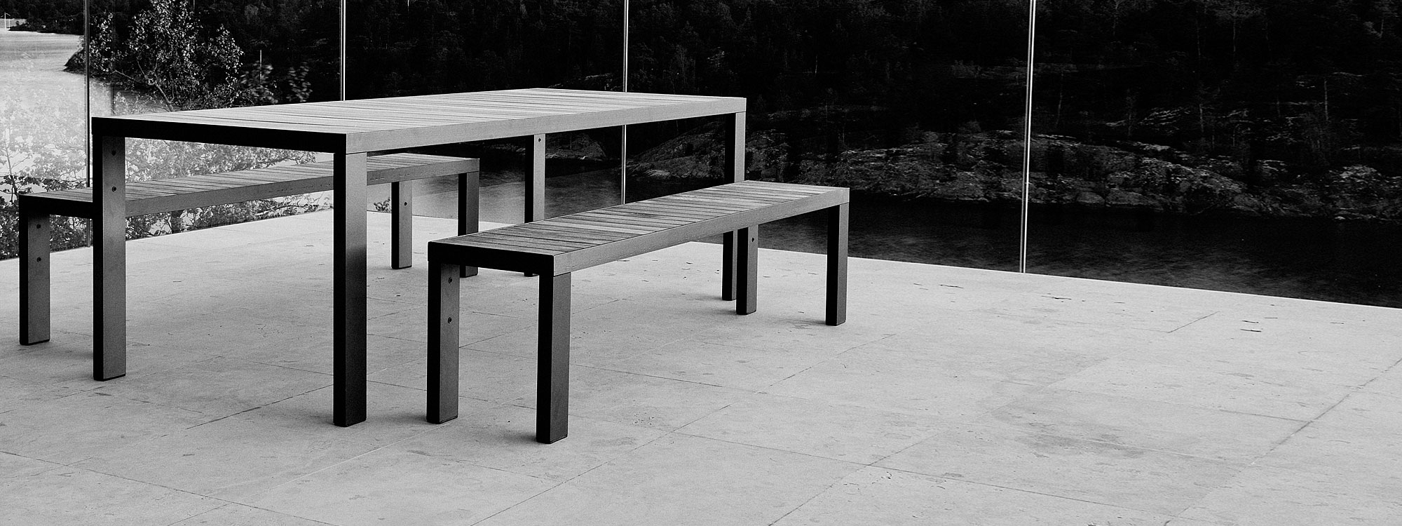 Monochrome image of Roshults modern garden table and benches